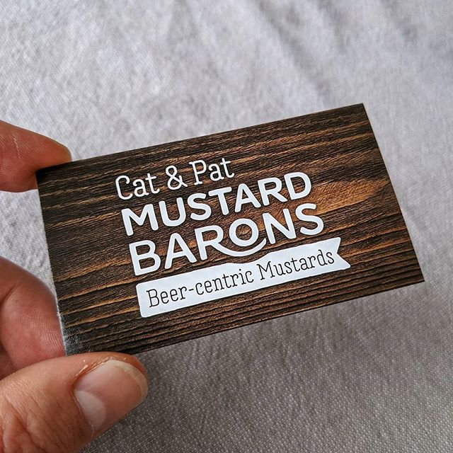 Printed Mustard Barons business card held in hand